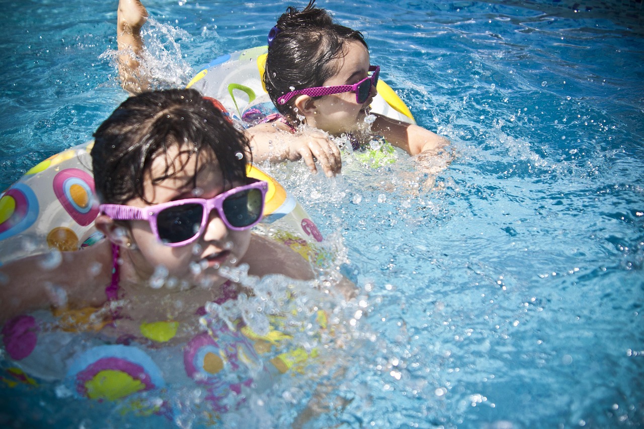 girls, swimming, splashing, sisters, little girls, nature, floaters, swim, swimming pool, pool, summer, vacation, splashing water, childhood, children, kids, shades, sunglasses, people, water, cute, wet, young, happy, joy, fun, activity, happiness